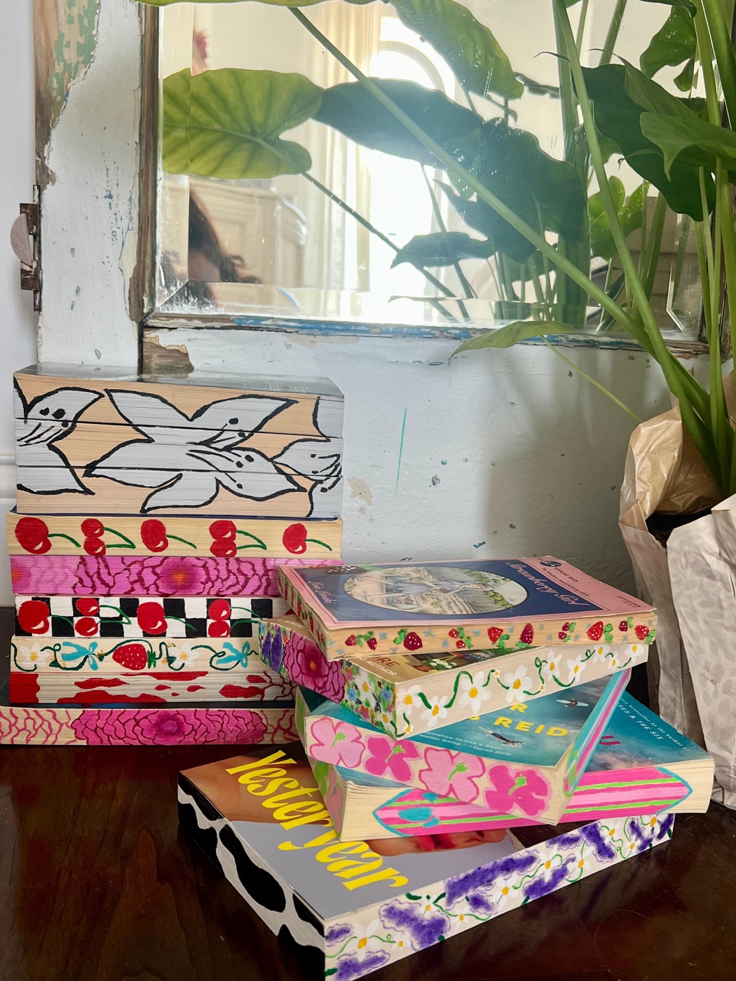 A collection of real Coo Crafts books with hand-painted floral, cherry and strawberry page edges